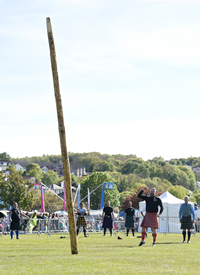 Lucas Venta tossing the caber in the final event before becoming 2019 Champion