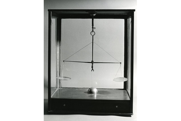 James Watt's Chemical Balance - 1978.390 © McLean Museum and Art Gallery, Greenock. The case is made of wood and glass. The front slides out and has a drawer underneath. The scale hangs from top, balance type and has two brass pans and two silver pans.