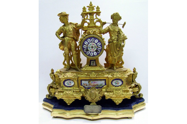 19th century gold painted cast iron presentation clock. The is inscribed: 'Presented to Mr. Thomas D. Rorison (along with a gem ring to Mrs Rorison) by the employees of Messrs. Crawhall Allison & Co. Sugar Refinery as a token of esteem, on the occasion of his leaving the works to occupy a better position. Greenock 14th July 1877'. - 1998.11 ©McLean Museum and Art Gallery, Greenock.