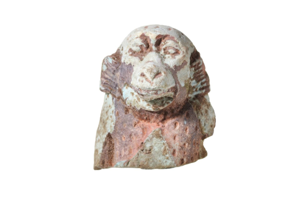Mould-made amulet in glazed composition, in the shape of a Vervet monkey. Made in Egypt between the 6th century BC and 4th century BC. Excavated at the Scarab Factory, Naukratis, Nile Delta, Egypt between 1884 and 1886 by Sir William Matthew Flinders Petrie (1853-1942). - 1987.454 © McLean Museum and Art Gallery, Greenock.