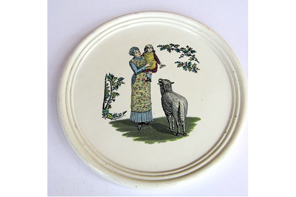Late 19th century glazed wall plaque decorated with a design of a woman holding a child in her arms and sheep in foreground. Decorative foliage on either side. Made between 1862 and 1900 by the Clyde Pottery Company, Greenock. - 2011.99 - © McLean Museum and Art Gallery, Greenock.