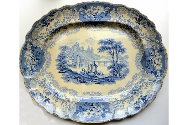 A late 19th century large glazed ceramic ashet or serving plate manufactured by the Clyde Pottery Company of Greenock (1862-1900). Decorated in blue with the 'British Rivers' pattern. - 2012.65 - © McLean Museum and Art Gallery, Greenock.