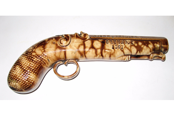 A mid 19th century glazed ceramic decorative pistol manufactured by the Clyde Pottery, Greenock with a glazed surface in mid and light brown colour.
Inscription stamped on the barrel: 'John Philips Greenock 1867'. - 1977.129 - © McLean Museum and Art Gallery, Greenock.