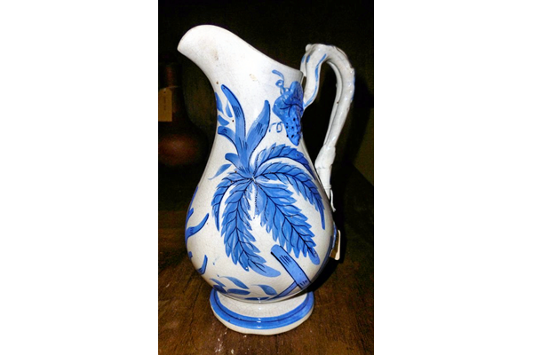 Late 19th century glazed ceramic jug manufactured by the Clyde Pottery Company, Greenock. The jug has a hand painted design on a white background with a mid blue design of plant foliage and forget-me-nots. - 1981.1594 - © McLean Museum and Art Gallery, Greenock.