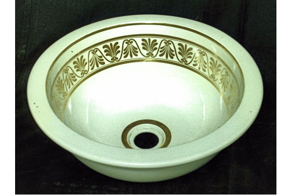 Late 19th century glazed ceramic wash basin manufactured by the Clyde Pottery, Greenock.
Decorated in white with plug hole in centre surrounded by gold line; gilded decoration on inside; gilded lambrequin design bordered with gilt line top and bottom. - L1977.117 - © McLean Museum and Art Gallery, Greenock.