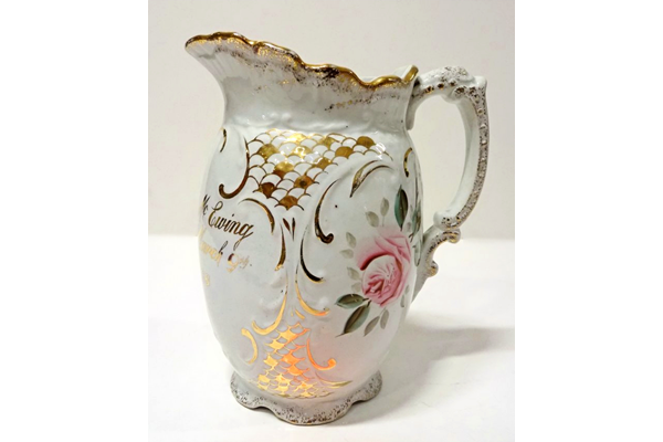 Glazed ceramic marriage jug manufactured by the Clyde Pottery Company, Greenock. Decorated with the 'Murray Rose' pattern and inscribed 'Mrs David McEwing Married March 9th 1898'. - 1980.109 - © McLean Museum and Art Gallery, Greenock.