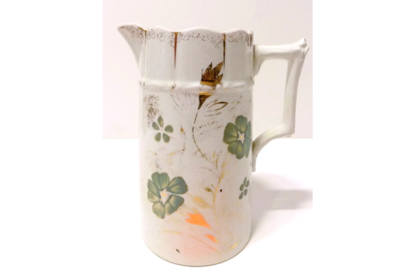 Glazed ceramic jug manufactured by the Clyde Pottery Company, Greenock. Decorated with a hand painted design, a white background and a design of green flowers and gilded strips. - 1980.108 - © McLean Museum and Art Gallery, Greenock.
