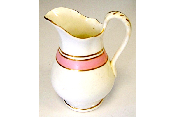 Milk jug manufactured by Thomas Shirley & Co. (the Clyde Pottery Company, Greenock) sometime between 1844 and 1857. Decorated in white with pink stripe and gilded decoration. - 2001.294 - © McLean Museum and Art Gallery, Greenock.