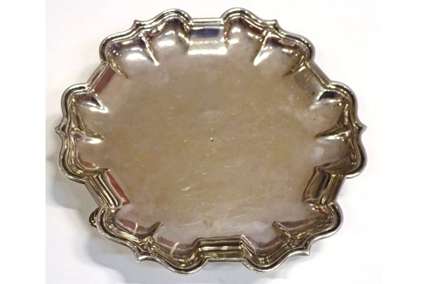 Mid eighteenth century Greenock provincial silver waiter made by John Taylor (fl 1750-1785). The waiter has a circular, fluted edge with points. Four hallmarks on underside at edge: 'IT', 'S', 'S' and 'IT'. - 2001.5 - ©McLean Museum and Art Gallery, Greenock.