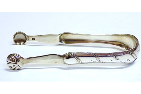 Greenock provincial silver sugar tongs. George III fiddle pattern with shell bowls and oblique fluted pattern on sides and with and engraved monogram 'A' on convex part. Two assay marks: an anchor for Greenock. Makers' mark 'AR' set inside rectangle on each limb above bowl on the inside. Dated around 1780. - 1980.33 - ©McLean Museum and Art Gallery, Greenock.