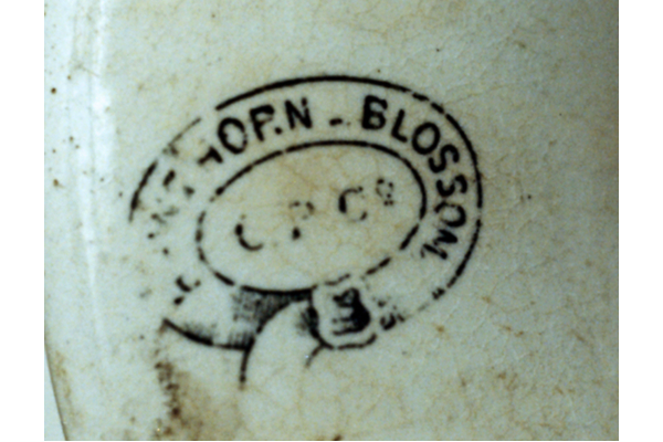 ‘Hawthorn Blossom’ uses sprays of hawthorn, well-drawn, printed in various colours and often with hand painted overglaze, usually on found on punch-bowls or mugs. Also with lustre border-band and red-orange rim-line. Mark is on an oval garter with C.P.Co. central. © McLean Museum and Art Gallery, Greenock.