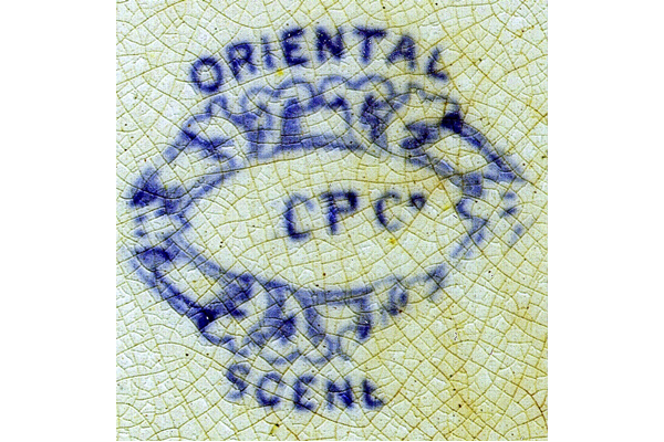 ‘Oriental Scenery’ pattern features an oriental lake with terracing in the foreground, feathery palm-tree, distant river mountains and border. The background is a chess-board pattern; blue printing. The oval cartouche contains the mark C.P.CO. offset to the right and sometimes the mark T.C.P.Co., with the T faint, indicating the Shirley period and use by their successors. Also found with impressed maple-leaf with C.P.COY with serifs. © McLean Museum and Art Gallery, Greenock.