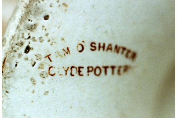This pattern and mark are found on a great variety of ware, but mainly punch bowls and wall plaques. Mark is TAM O'SHANTER, curved over CLYDE POTTERY. © McLean Museum and Art Gallery, Greenock.