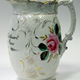 Late 19th century glazed ceramic marriage milk jug manufactured by the Clyde Pottery Company Limited, Greenock (1900-1905). Decorated with the 'Murray Rose' pattern and inscribed 'Mrs John Cathcart married 19th June 1903'. The name for this pattern of painted overglaze wares with rose-sprays is derived from Murray, the Clyde Pottery's gilder. - 2005.80 - © McLean Museum and Art Gallery, Greenock.