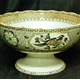 Mid 19th century glazed ceramic punch bowl manufactured by the Clyde Pottery Company, Greenock. Decorated with the 'Cabul' pattern of Tudor roses and tropic birds in reserves, on a border of Persian swastikas with a centrepiece of Chinese furniture & plants. The Cabul pattern seems to have been produced between 1863 and 1875. - 1987.542 - © McLean Museum and Art Gallery, Greenock.