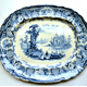 Mid 19th century glazed ceramic ashet or serving plate manufactured by Thomas Shirley & Co. (the Clyde Pottery Company, Greenock) sometime between 1840 and 1857. Decorated with the 'Continental Cathedrals' pattern. Purchased with grant-aid from the National Fund for Acquisitions. - 1987.646