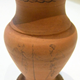 One of a pair of late 19th century commemorative unglazed terracotta amphora shaped vases manufactured by the Clyde Pottery Company, Greenock. - 1977.161 - © McLean Museum and Art Gallery, Greenock.