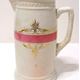 Glazed ceramic jug manufactured by the Clyde Pottery Company, Greenock. Decorated with pink stripe and gilding. Purchased with grant-aid from the National Fund for Acquisitions. - 1987.691 - © McLean Museum and Art Gallery, Greenock.