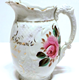 Marriage jug manufactured by the Clyde Pottery Company Limited, Greenock 1900-1905. Decorated with the 'Murray Rose' pattern and inscribed 'Mr & Mrs Joseph McReynolds Married 2nd July 1901'. - 1997.111 - © McLean Museum and Art Gallery, Greenock.