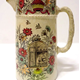 Jug manufactured by the Clyde Pottery Company, Greenock between 1862 and 1900. Decorated with the 'Cottage' pattern. - 2001.26  - © McLean Museum and Art Gallery, Greenock.