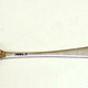 Silver dessert spoon made by Jonas Osborn (fl 1790). Old English style with engraved initial 'J' and drop hell. Three marks: 'I.O.' (Jonas Osborne), an anchor and capital letter 'G' the date mark for 1790. - 1982.3 - ©McLean Museum and Art Gallery, Greenock.