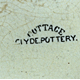 This pattern was used on jugs in the form of round-headed side-reserves with cottage picture; surrounded with spray of Michaelmas daisies; the top border has bishop's mitres & ribbons with daisy-spray mark in capitals. The mark is COTTAGE (curved) over CLYDE POTTERY. © McLean Museum and Art Gallery, Greenock.