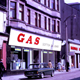 Colour transparency by Eugene Jean Méhat (1920-2000) showing a scene in Greenock during the mid 1960s. This shows a view dated 25-8-67 showing West Blackhall Street with Gas Board showroom, MacDonald Cleaners and Hector Russell shop. - 2008.72.154  - © McLean Museum and Art Gallery, Greenock.