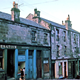 Transparency by Eugene Jean Méhat (1920-2000) showing a view of Ann Street, Greenock with the premises of Greenock Co-operative shop and the Greenock Morton Development Club. - 2008.72.215  - © McLean Museum and Art Gallery, Greenock.   